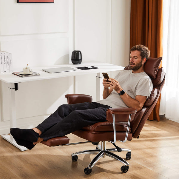 Close-up of black leather executive chair seat with chrome base and five wheels for office use.